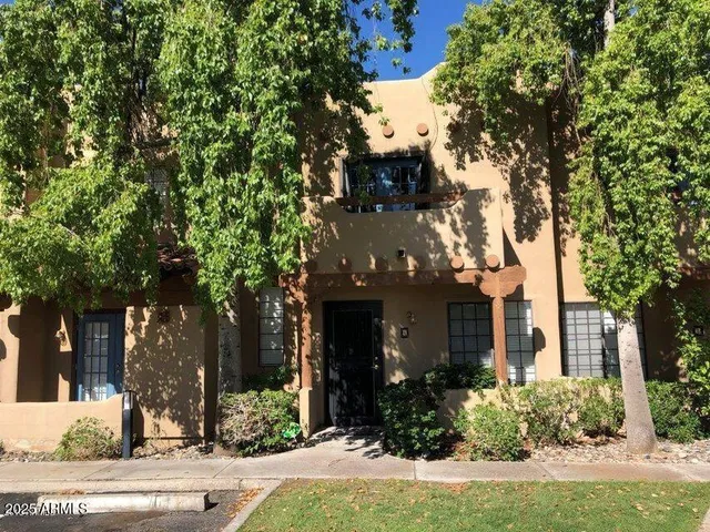 front view of a house with a tree