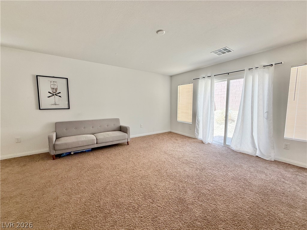 7777 South Westwind Road Las Vegas, NV 89139 - Photo 12 of 46 A spacious common area with plush carpeting awaits your personal touch.