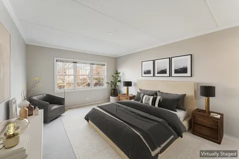 a bedroom with a bed a couch and a window