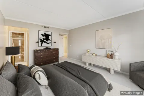 a bedroom with a bed and a couch