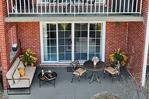 a balcony with furniture and flowers