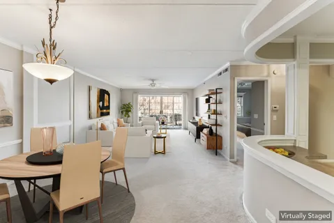 a view of a dining room with furniture and a chandelier