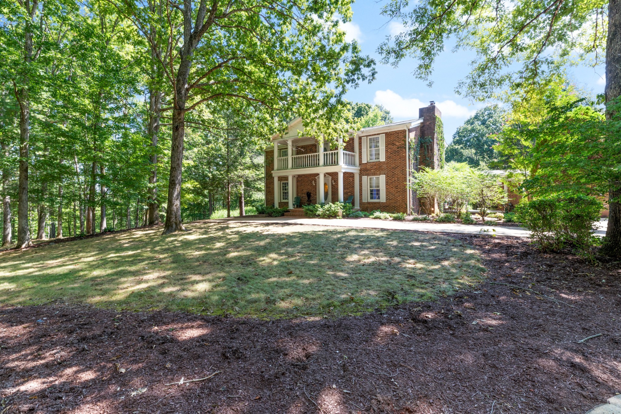 a backyard of a house with lots of green space