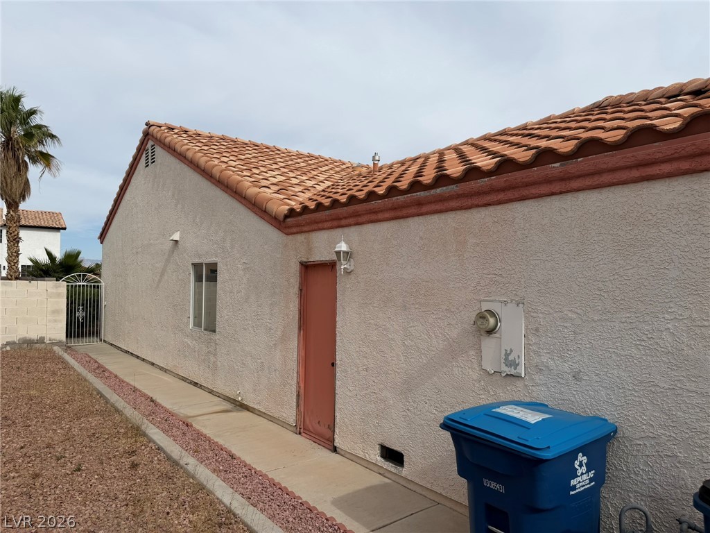 277 Gentle Bay Avenue Henderson, NV 89074 - Photo 42 of 43 This exterior view highlights the home's tiled roof and stucco finish.