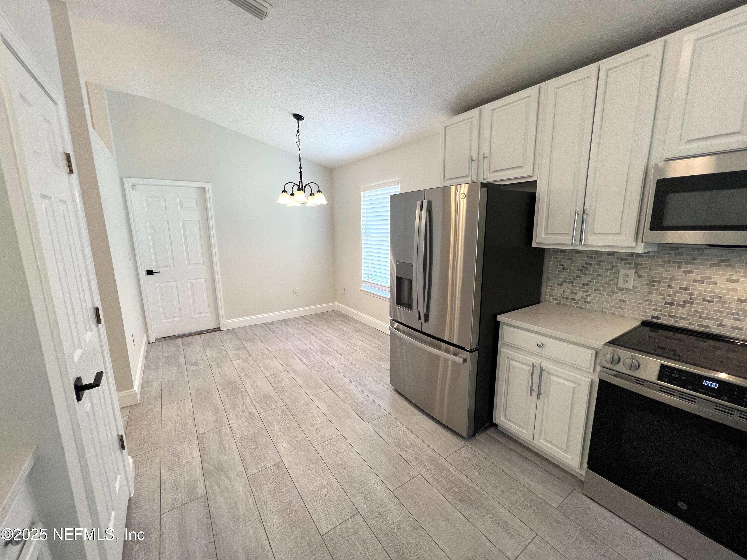 677 MacKenzie Circle St. Augustine, FL 32092 - Photo 17 of 92 a kitchen with stainless steel appliances a refrigerator stove and microwave