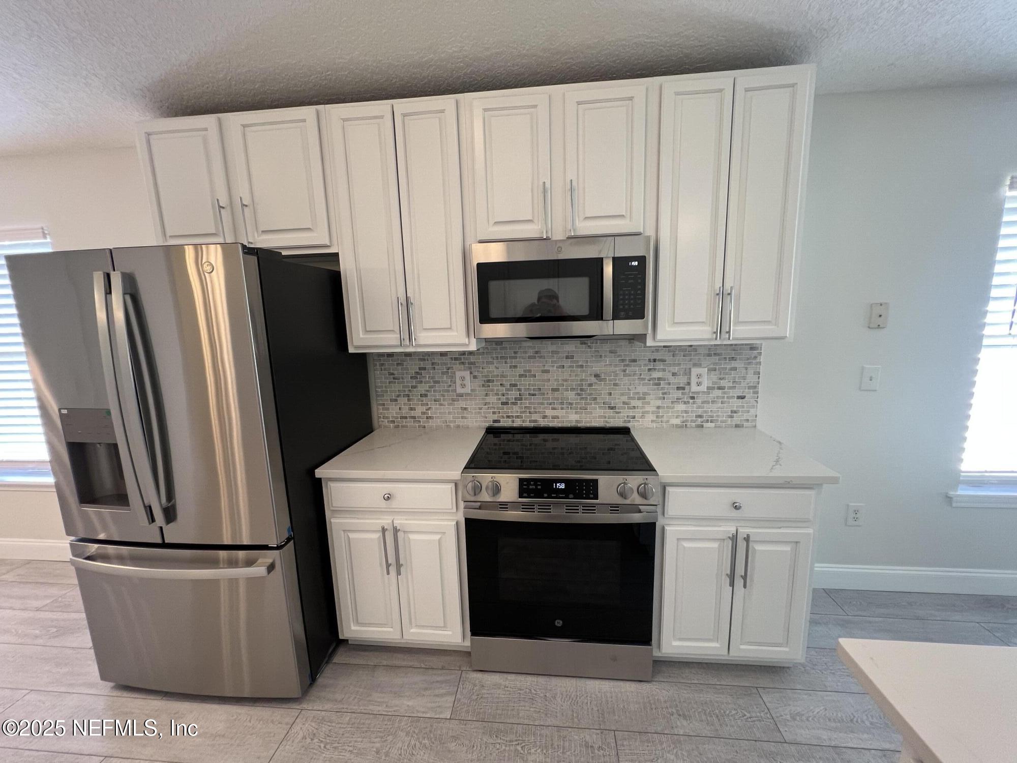 677 MacKenzie Circle St. Augustine, FL 32092 - Photo 18 of 92 a kitchen with cabinets stainless steel appliances and a counter space