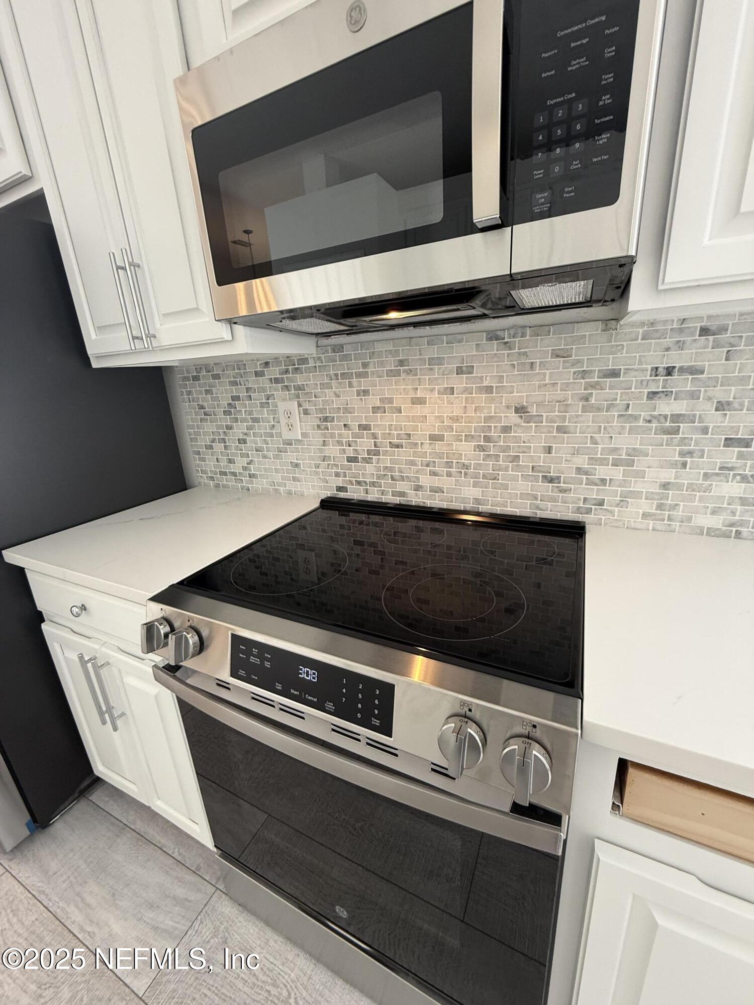 677 MacKenzie Circle St. Augustine, FL 32092 - Photo 24 of 92 a view of kitchen with microwave and stove