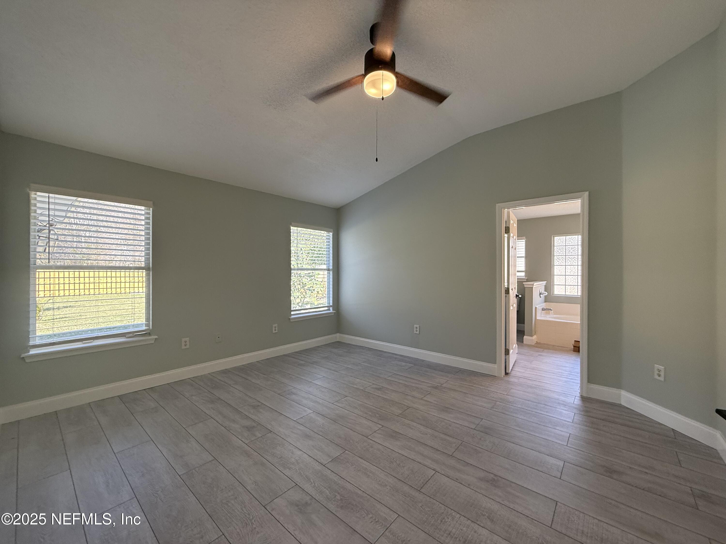 677 MacKenzie Circle St. Augustine, FL 32092 - Photo 41 of 92 a view of an empty room with window and wooden floor