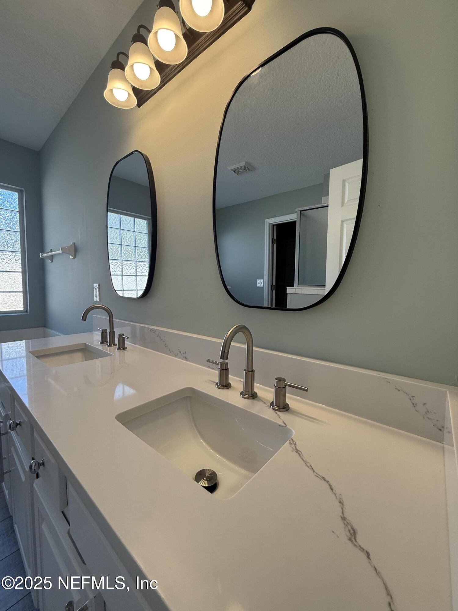 677 MacKenzie Circle St. Augustine, FL 32092 - Photo 44 of 92 a bathroom with a sink and a mirror