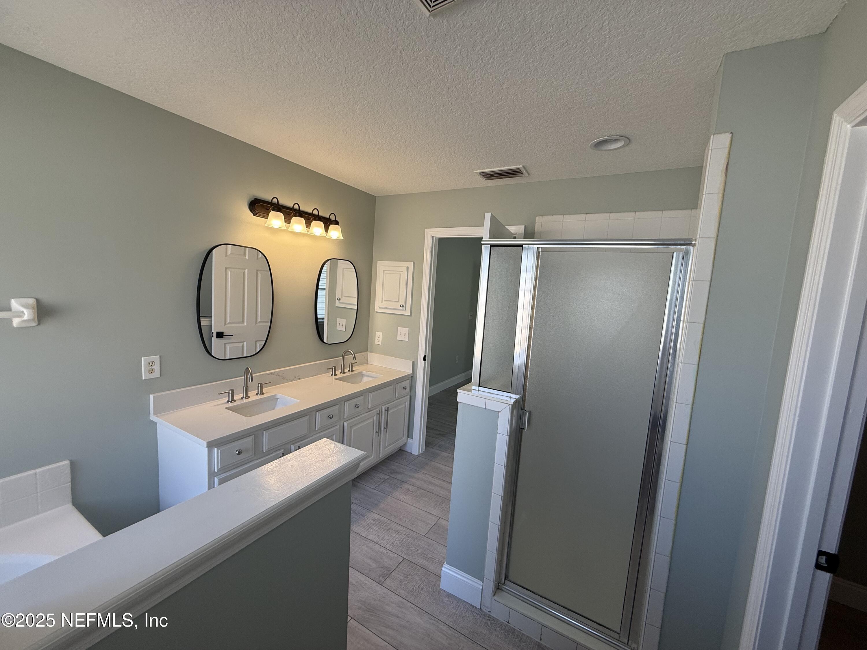 677 MacKenzie Circle St. Augustine, FL 32092 - Photo 45 of 92 a bathroom with a mirror sink and mirror