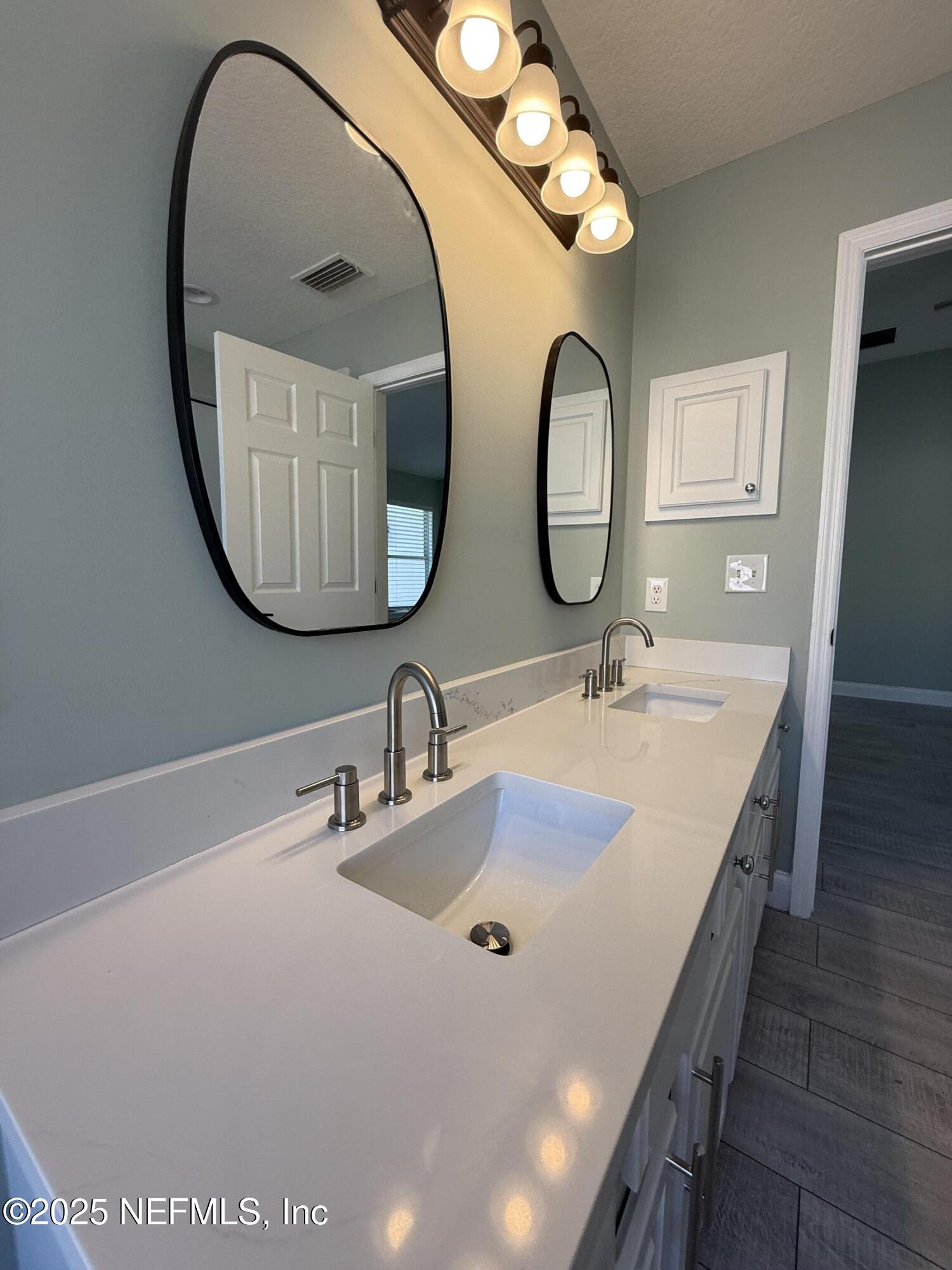 677 MacKenzie Circle St. Augustine, FL 32092 - Photo 47 of 92 a bathroom with a sink and a mirror