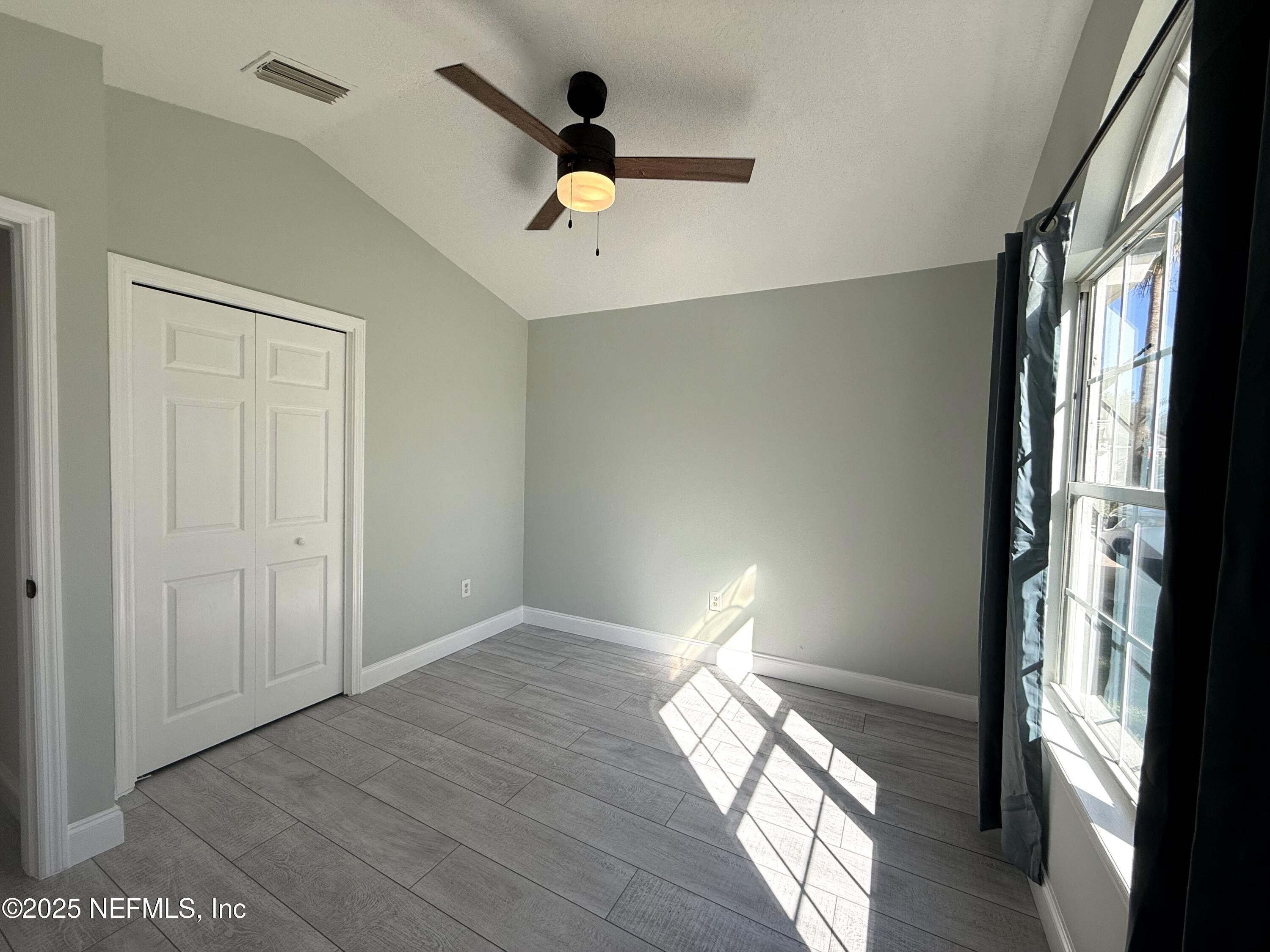 677 MacKenzie Circle St. Augustine, FL 32092 - Photo 49 of 92 a view of empty room with wooden floor and fan