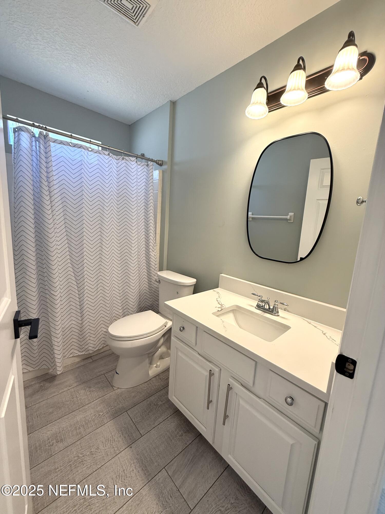 677 MacKenzie Circle St. Augustine, FL 32092 - Photo 51 of 92 a spacious bathroom with a toilet sink and mirror