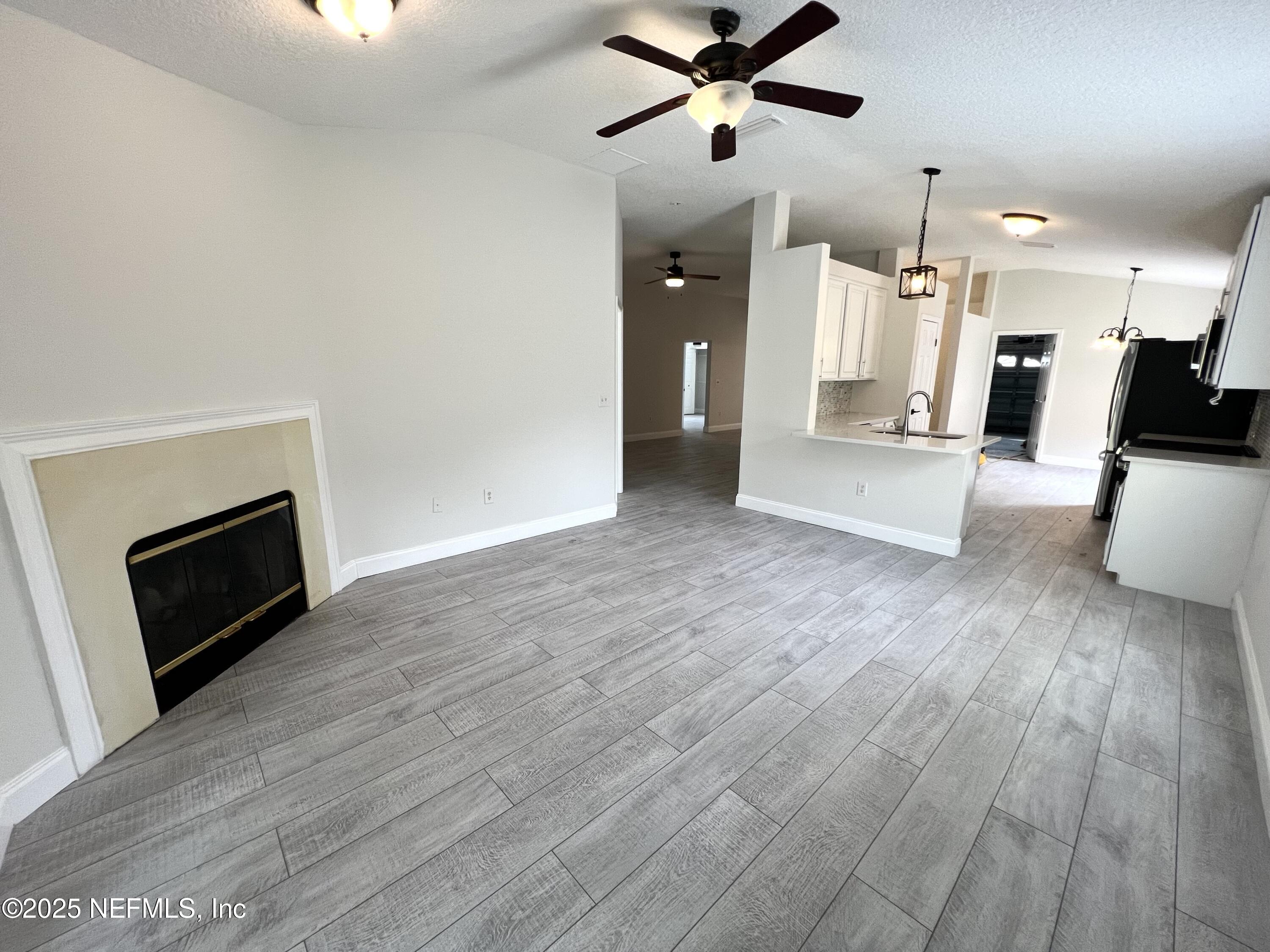 677 MacKenzie Circle St. Augustine, FL 32092 - Photo 69 of 92 a view of a living room a wooden floor and a fireplace