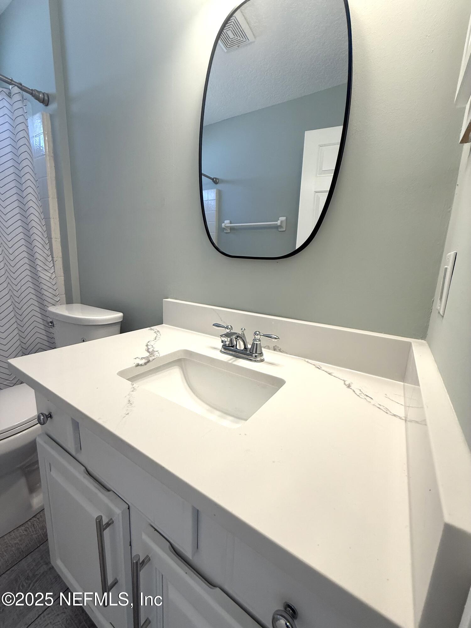 677 MacKenzie Circle St. Augustine, FL 32092 - Photo 73 of 92 a bathroom with a sink and a mirror
