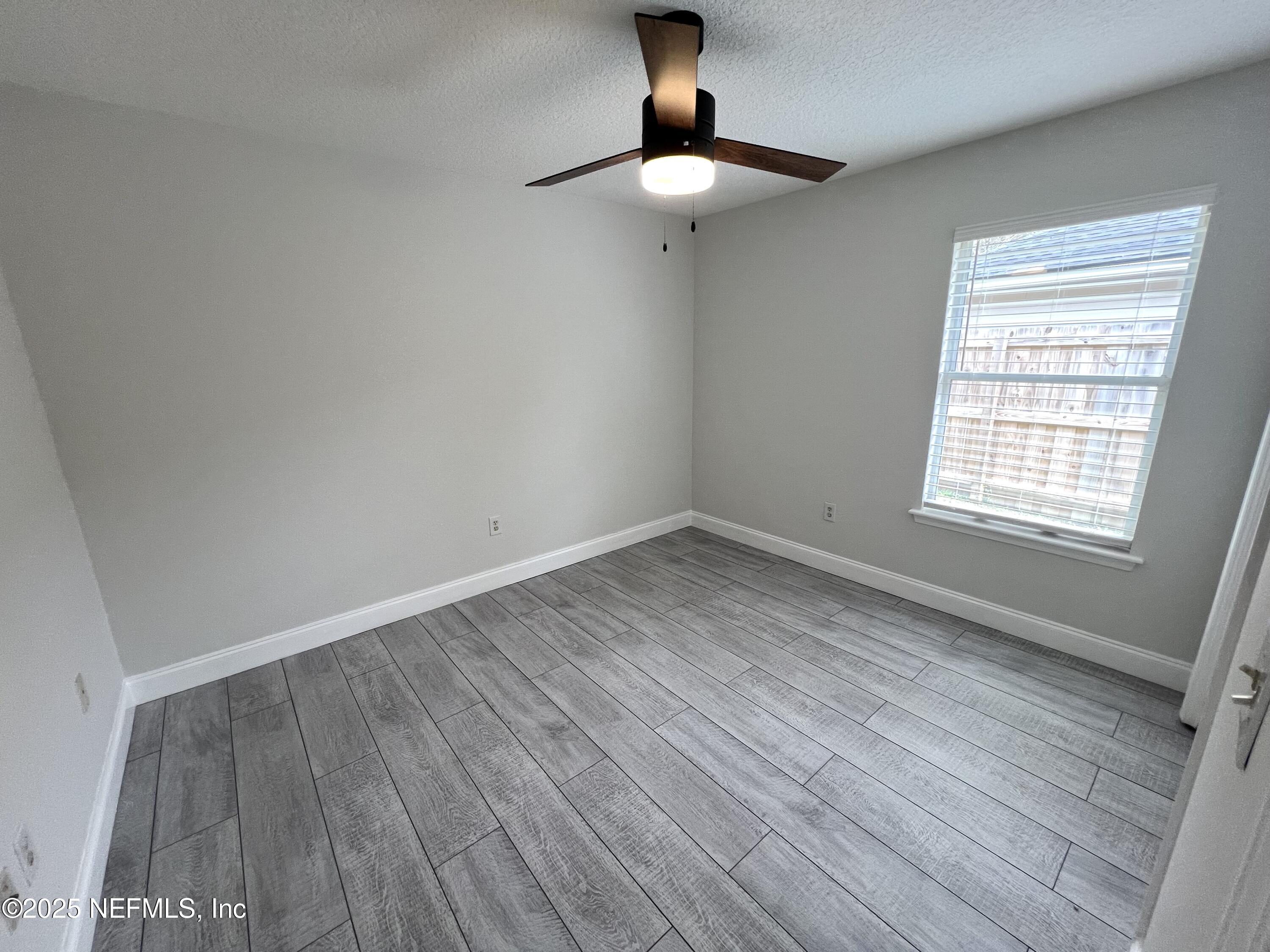 677 MacKenzie Circle St. Augustine, FL 32092 - Photo 76 of 92 a view of an empty room with wooden floor and a window