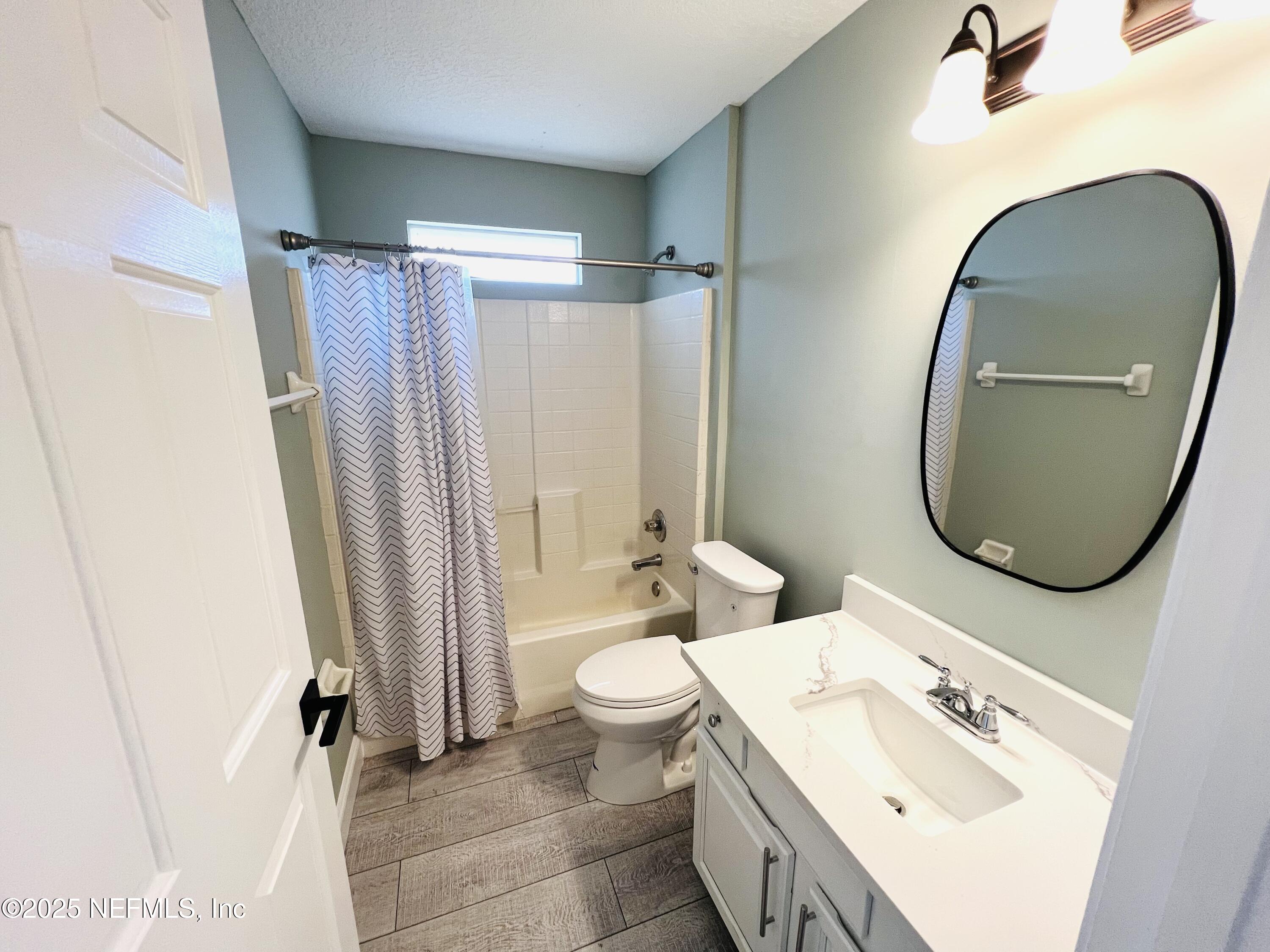 677 MacKenzie Circle St. Augustine, FL 32092 - Photo 77 of 92 a bathroom with a sink a toilet and a mirror