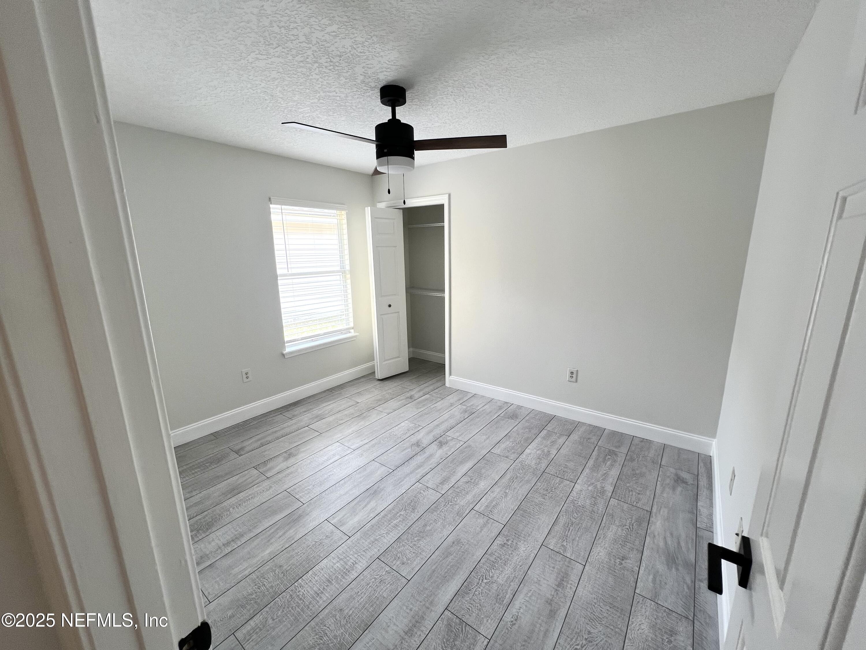 677 MacKenzie Circle St. Augustine, FL 32092 - Photo 78 of 92 wooden floor in an empty room with a window