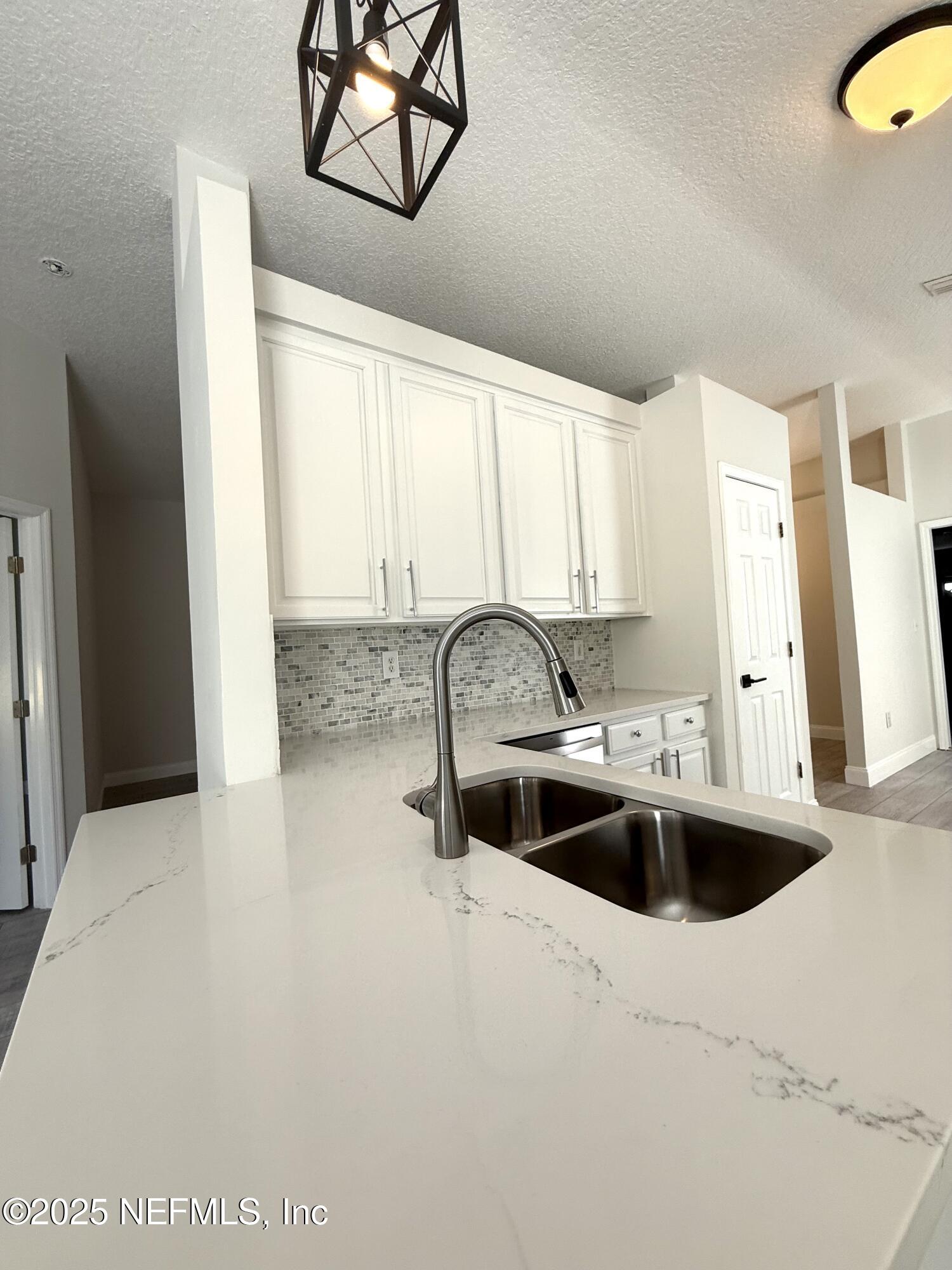 677 MacKenzie Circle St. Augustine, FL 32092 - Photo 8 of 92 a kitchen with a sink a stove and cabinets