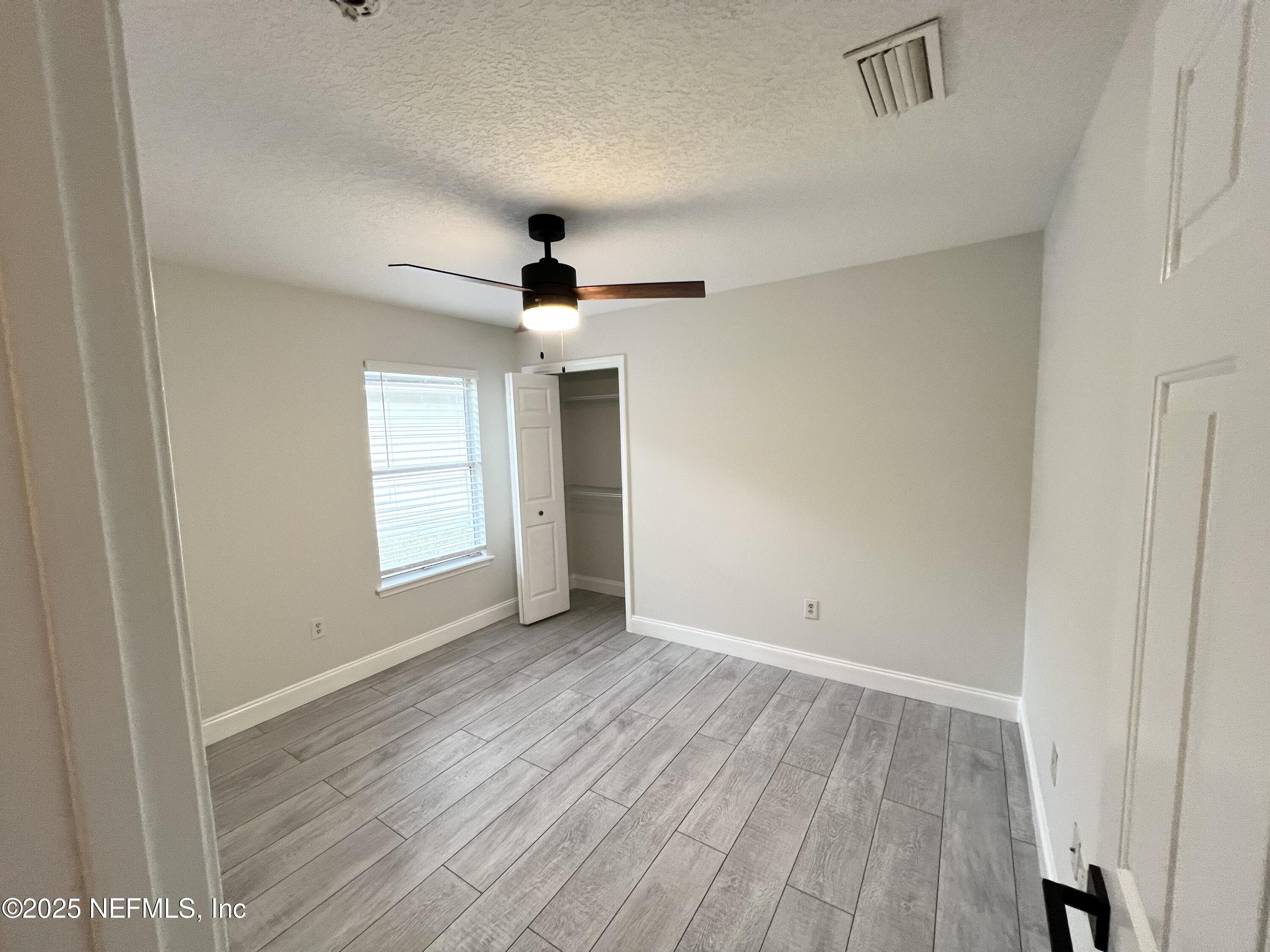 677 MacKenzie Circle St. Augustine, FL 32092 - Photo 90 of 92 a view of an empty room with wooden floor and a window