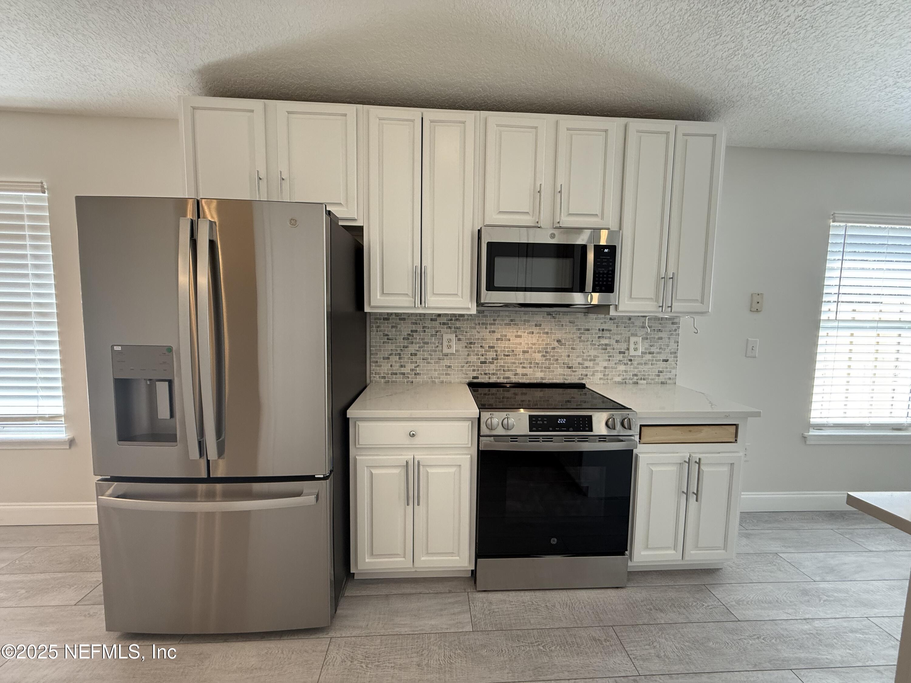 677 MacKenzie Circle St. Augustine, FL 32092 - Photo 9 of 92 a kitchen with appliances a sink and a window