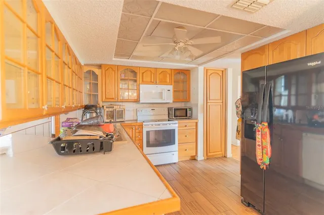 a spacious bathroom with a tub and a large window