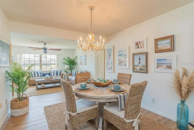 a view of a dining room with furniture wooden floor and chandelier