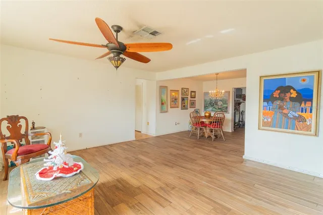 a living room with furniture and kitchen view