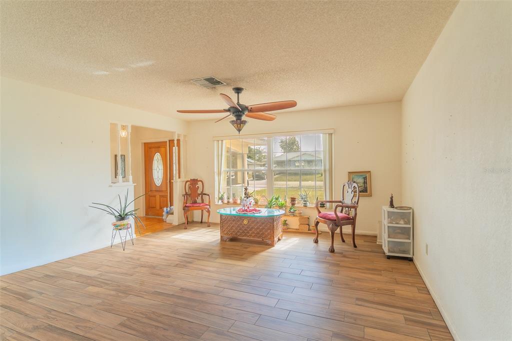 4202 Tangier Street Sebring, FL 33872 - Photo 16 of 29 a living room with furniture and a wooden floor