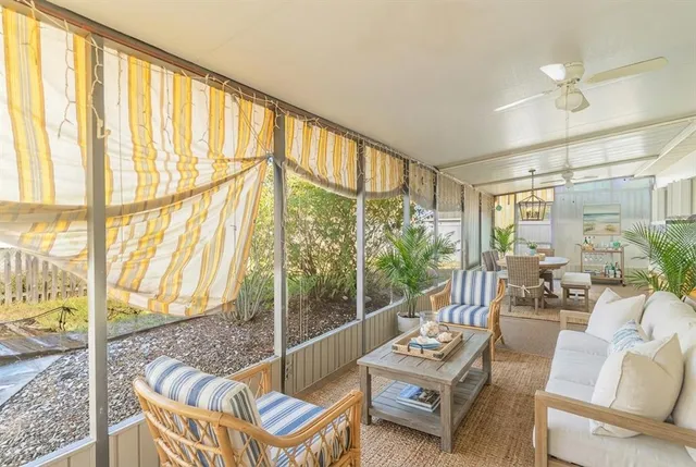 a living room with furniture and a floor to ceiling window