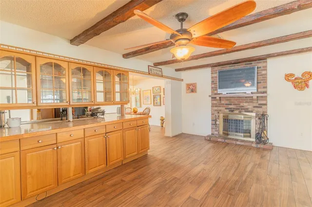 a large kitchen with cabinets and wooden floor