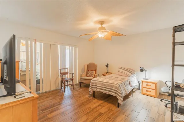 a bedroom with a bed and wooden floor
