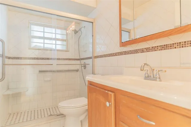 a bathroom with a sink a toilet and a mirror