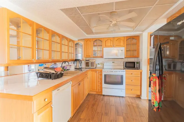 a kitchen with stainless steel appliances a sink window and cabinets