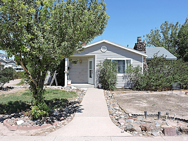355 South Center Street Delta, UT 84624 - Photo 17 of 21 Single-story residence featuring light gray siding and a concrete walkway