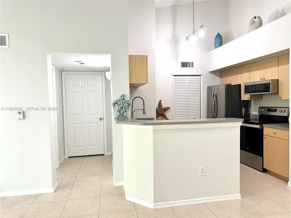 a kitchen with a sink a refrigerator and a stove