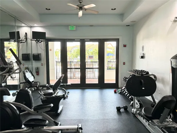 a room with gym equipment equipment and a large window