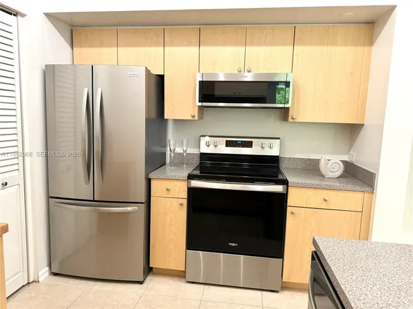 a kitchen with stainless steel appliances a refrigerator sink and cabinets