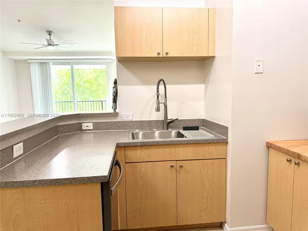 a kitchen with a sink cabinets and window