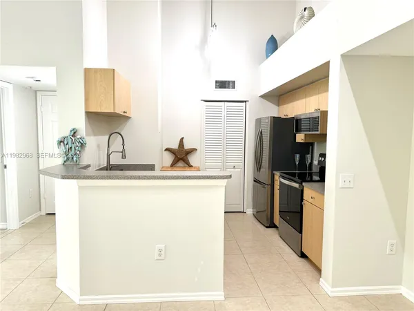 a kitchen with a sink and refrigerator