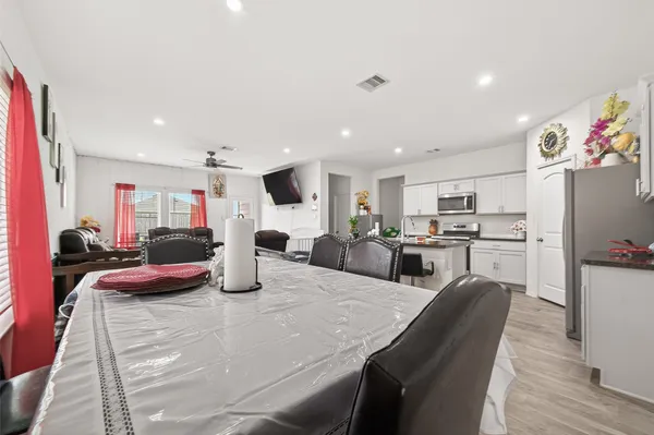 a kitchen with stainless steel appliances granite countertop a stove top oven a refrigerator a stove top oven and a sink