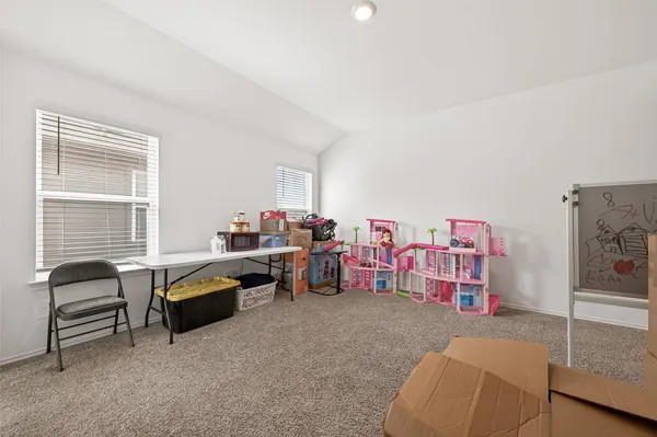 a room with a table and a chandelier