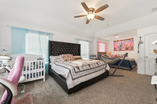 a bedroom with a bed and a dresser