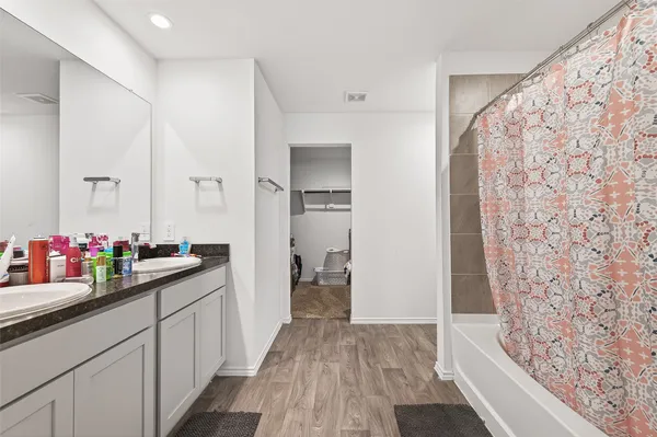 a bedroom with furniture and wooden floor