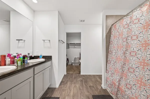 a bedroom with a bed and a ceiling fan