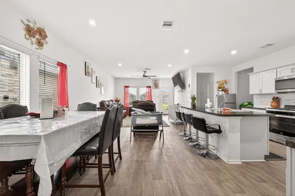 a kitchen with stainless steel appliances kitchen island granite countertop a sink and cabinets
