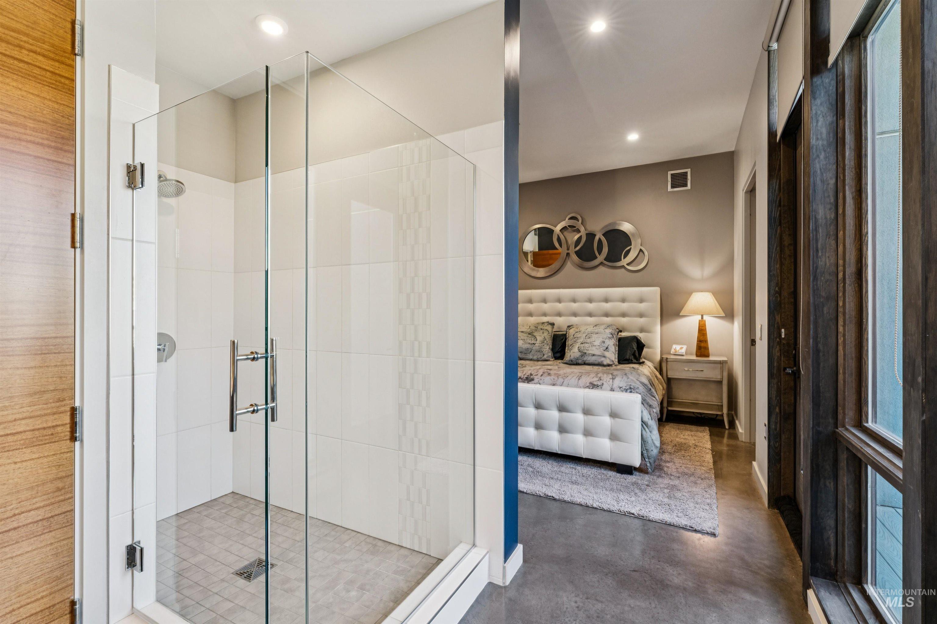119 South 10th Street, Unit 307 Boise, ID 83702 - Photo 23 of 47 Glass-enclosed shower with white tiled walls and a tiled floor