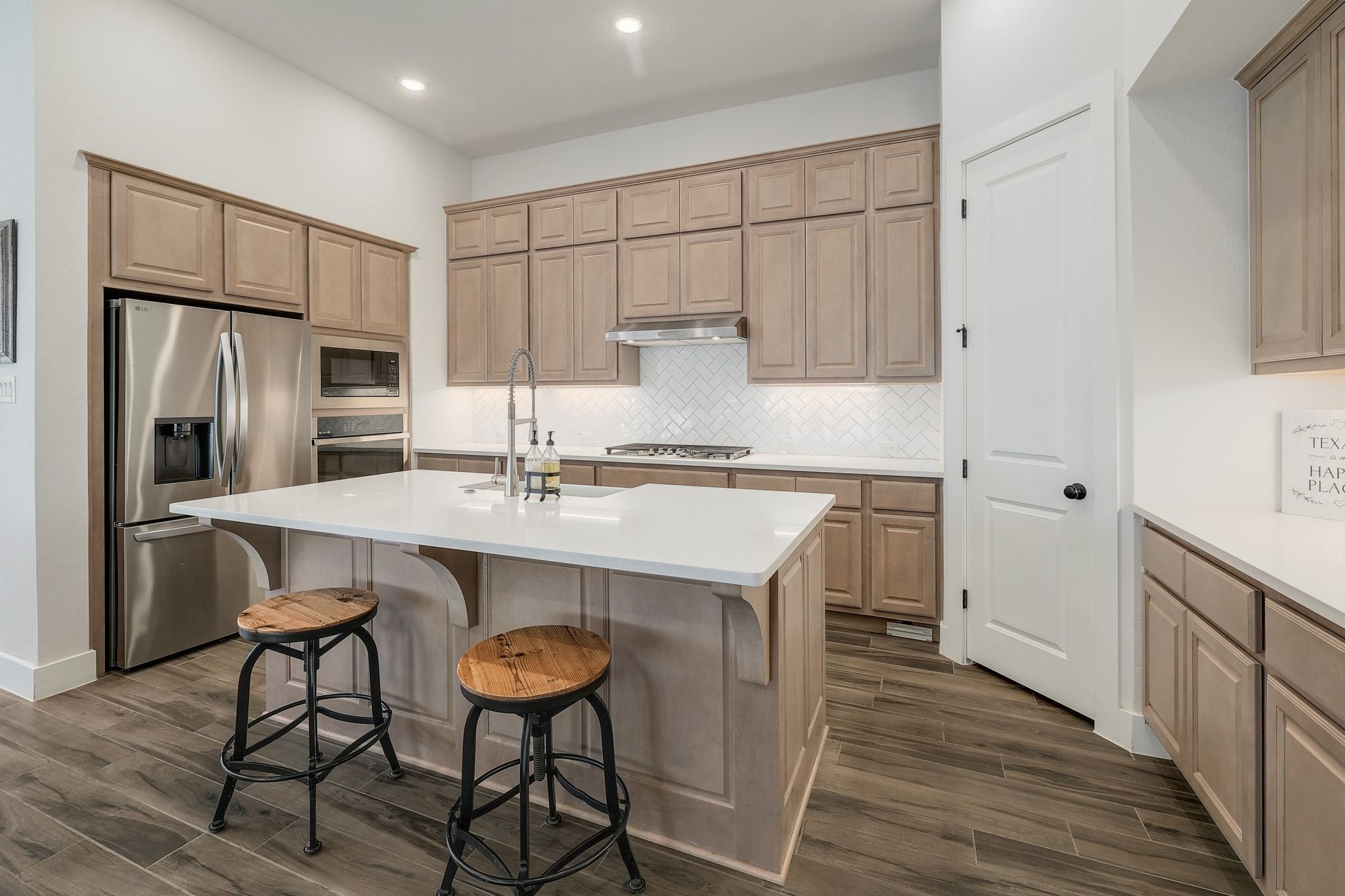 1304 Highcrest Georgetown, TX 78628 - Photo 12 of 32 a kitchen with stainless steel appliances a sink a stove a refrigerator and island with wooden floor