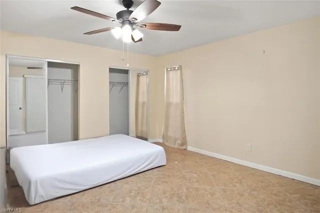 a view of a livingroom with a ceiling fan and window