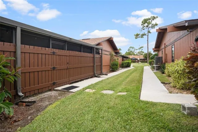 a view of a hallway with a table and chairs